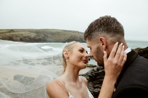 Bride and groom on Cornish cliff at Gunwalloe, documentary wedding photography
