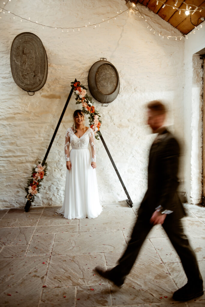 Wedding ceremony at Wonwood Barton Tavistock with black triangle arch and autumn flowers