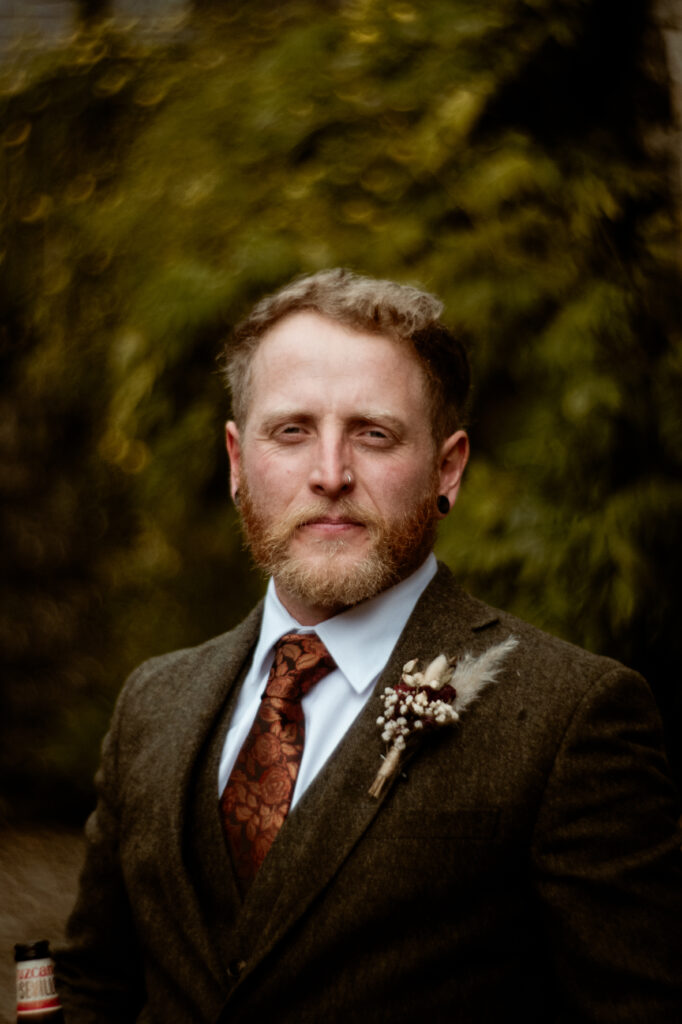 Groom in dark green tweed suit portrait at Wonwood Barton Tavistock Devon wedding